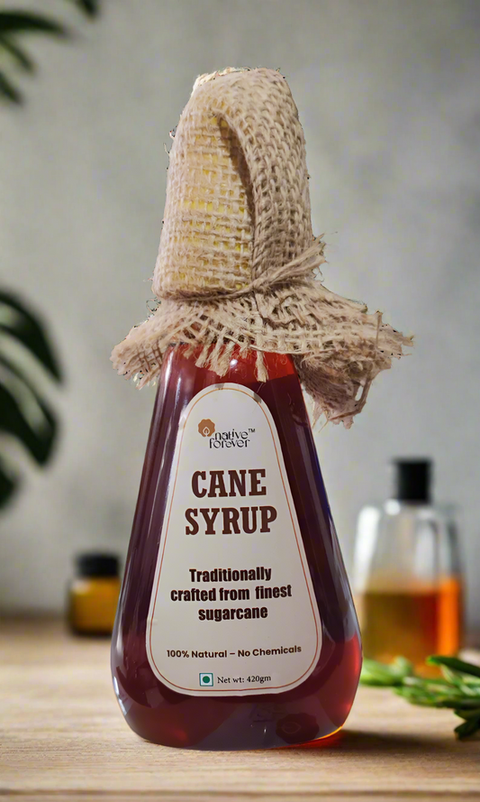 Bottle of cane syrup with a woven lid on a white background
